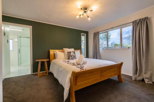 a bedroom with a large bed and a window at 27 on Henry - Te Anau Holiday Home in Te Anau
