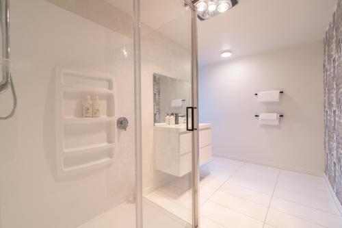 a bathroom with a shower and a glass door at 27 on Henry - Te Anau Holiday Home in Te Anau