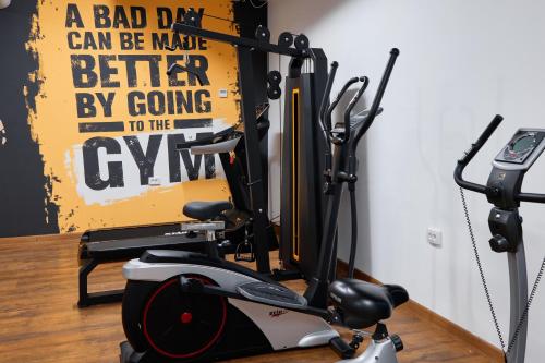 a gym with a treadmill and a cell phone at Diamond Hotel Shymkent in Shymkent