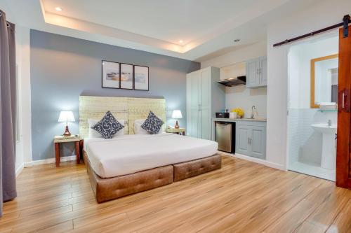 a large bedroom with a bed and a kitchen at The Mansion Boutique Hotel in Mabalacat