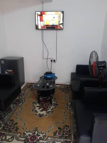 a living room with a couch and a table at Mountains View Villa in Freetown