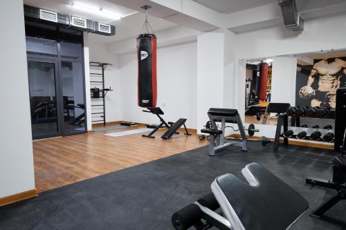 a gym with a bunch of equipment in a room at Diamond Hotel Shymkent in Shymkent