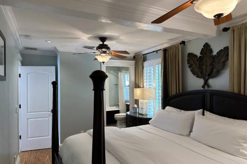 a bedroom with a bed with a ceiling fan at Bahama Breeze Bungalow Vacation Rental in West Palm Beach