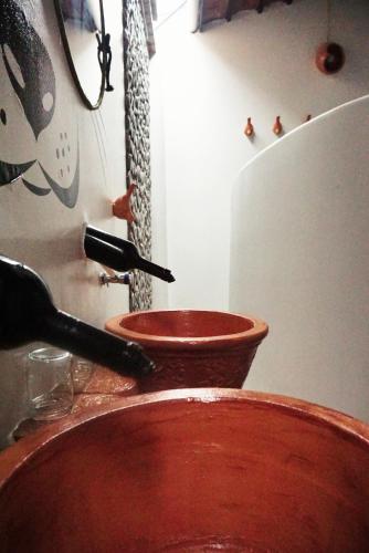 a wooden bowl with a utensil sticking out of it at Mekong Pottery Homestay, Green-Friendly & Boat Tour in Vĩnh Long