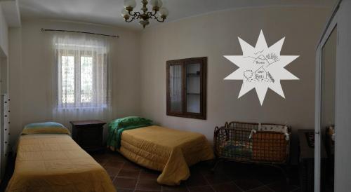a bedroom with two beds and a star on the wall at Pizinno CasaPonzi in Tortora