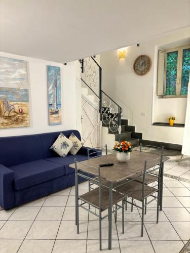 a living room with a blue couch and a table at Mediterraneo Apartment in Ercolano