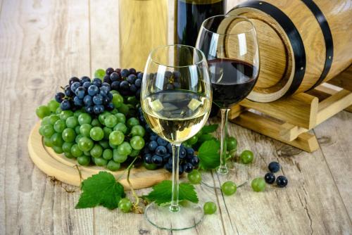 two glasses of wine next to a plate of grapes at Sofia in Kutaisi