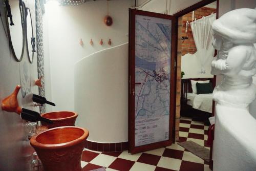 a bathroom with two toilets and a map on the wall at Mekong Pottery Homestay, Green-Friendly & Boat Tour in Vĩnh Long