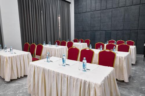 a group of tables and chairs in a room at Diamond Hotel Shymkent in Shymkent