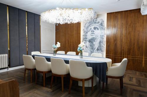 a large dining room with a table and chairs at Diamond Hotel Shymkent in Shymkent