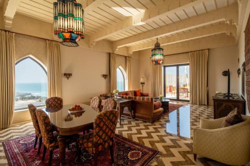 a living room with a table and chairs at Sofitel Bahrain Zallaq Thalassa Sea & Spa in Manama