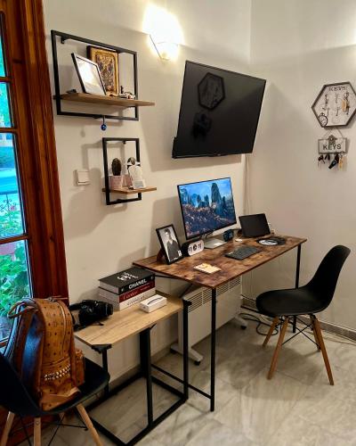 a room with a desk with a computer on it at Mpoufidis Rock House Meteora in Kalabaka