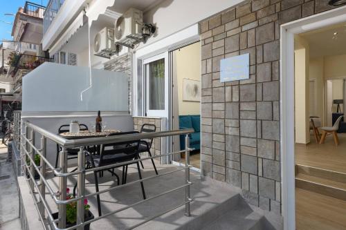 a room with a table and chairs on a balcony at Chara Sea View Luxury House in Limenas