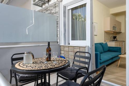 a table and chairs in a small room with a couch at Chara Sea View Luxury House in Limenas