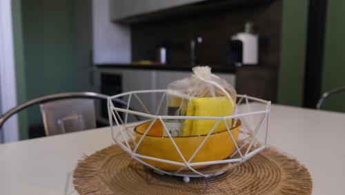 a basket of fruit sitting on a table at Ostello Loft La Fabbrica in Settimo Torinese