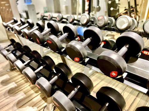 a row of dumbbells lined up in a gym at Ramada Encore by Wyndham Makati in Manila