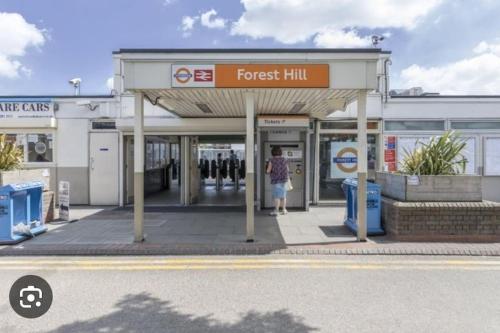 a person standing at a forest hill gas station at Zion Property in Sydenham