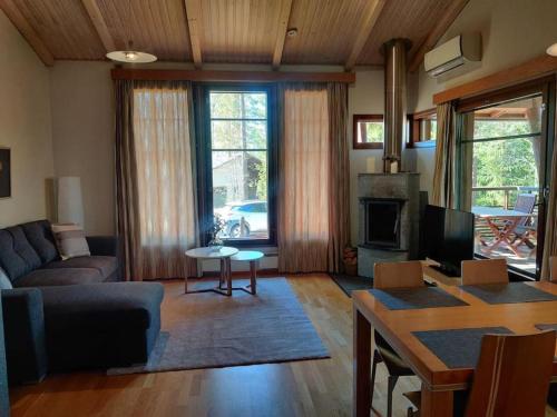 a living room with a couch and a table at Kylpyla Spa, Saimaa Villa Efrat B8 in Imatra