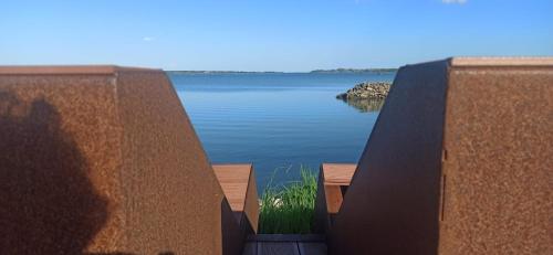 a view of a lake from between two retaining walls at Casa Vacanze Nel Delta del Po in Taglio di Po