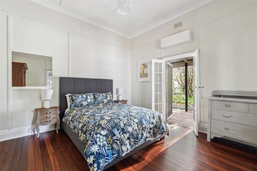 a bedroom with a bed and a dresser at Serenity House Pemberton Cottage & Wellness Spa in Pemberton