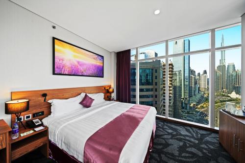 a hotel room with a bed and a large window at Park Regis Business Bay in Dubai