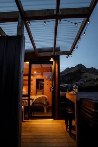 a room with a bedroom with a bed and a window at Cass Bay Retreat with Outdoor Bath Christchurch in  Lyttelton