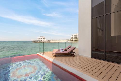 a view of the ocean from the balcony of a house at Sofitel Bahrain Zallaq Thalassa Sea & Spa in Manama