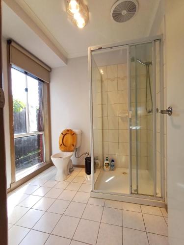 a bathroom with a shower and a toilet at YF Home Sweet Home FREE WIFI 4 bedroom beautiful house in Craigieburn