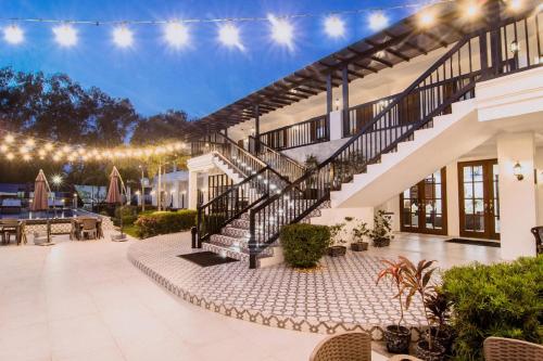 a house with a staircase and a patio at The Mansion Boutique Hotel in Mabalacat