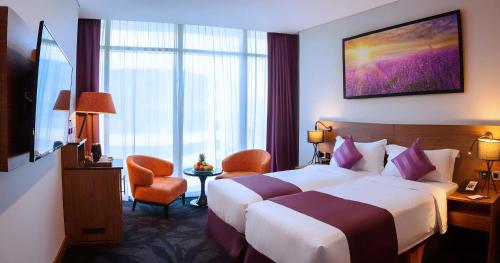 a hotel room with a bed and a large window at Park Regis Business Bay in Dubai