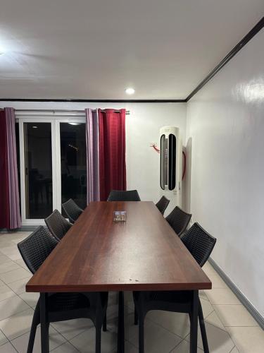 a conference room with a wooden table and chairs at Clark stay in Fort Stotsenburg