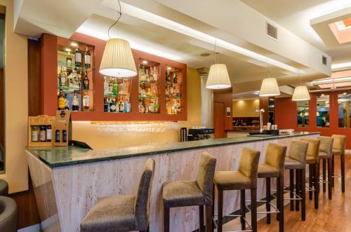 a bar with a row of stools at TURIM Europa Hotel in Lisbon