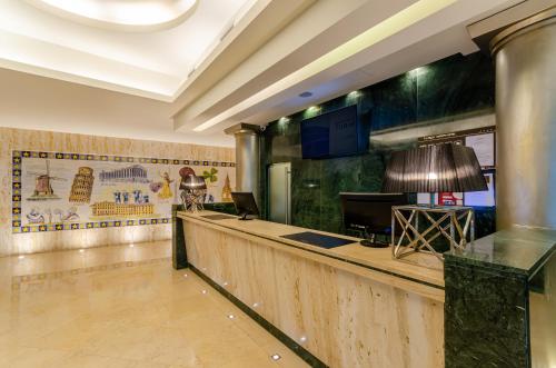 a hotel lobby with a bar with a lamp at TURIM Europa Hotel in Lisbon