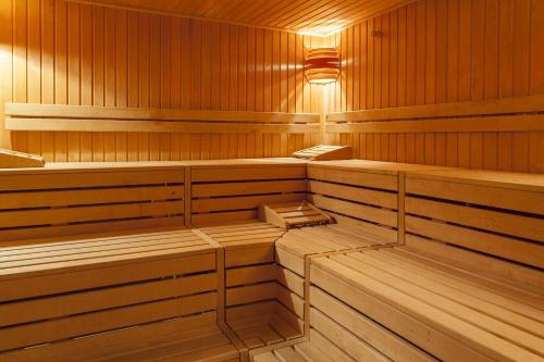 a sauna with wooden benches and a light in it at Landgasthof Karner in Frasdorf