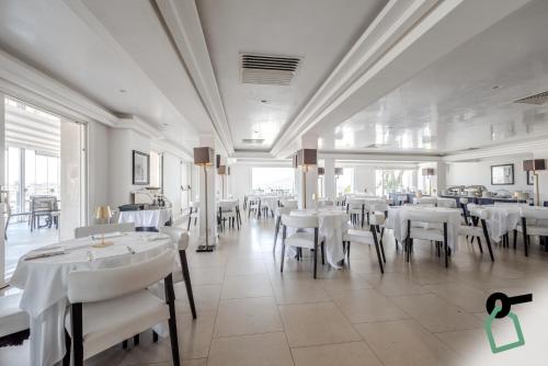 a dining room with white tables and white chairs at HOTIDAY Room Collection - Napoli Diaz in Naples