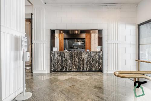 a lobby with a bar in the middle of a room at HOTIDAY Room Collection - Napoli Diaz in Naples