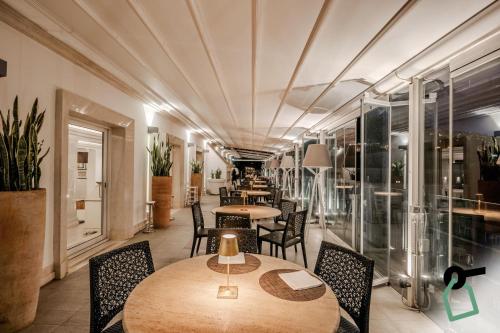 a restaurant with tables and chairs in a room at HOTIDAY Room Collection - Napoli Diaz in Naples