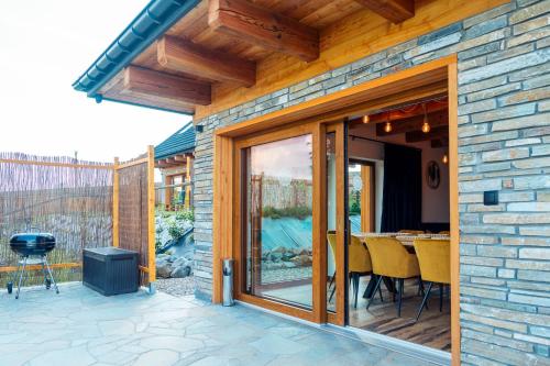 a patio with sliding glass doors and a grill at Kasztanowe Zacisze in Jaworzynka