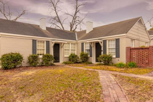 a white house with a gambrel roof at The Delightful Doubles- Unit A- Centrally Located in Columbus
