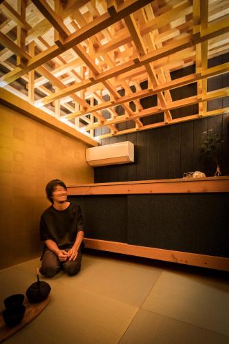 a man sitting on the floor under a ceiling at CONTEXTED-Sora SORA - Vacation STAY 78119v in Osaka