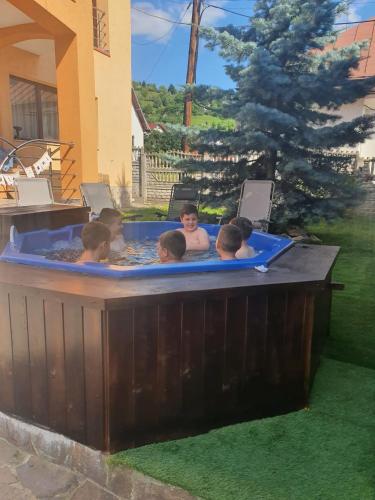 a group of people in a hot tub at CASA LAURENTIU in Borşa