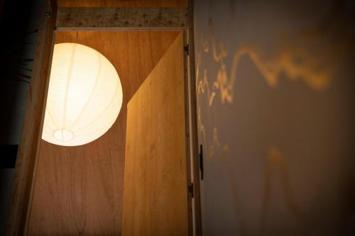 a light that is on top of a wooden door at CONTEXTED-Sora SORA - Vacation STAY 78119v in Osaka