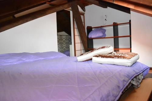 a bed with two pillows on top of it at Villa Gioia in Acqui Terme