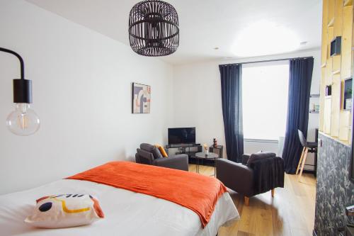 - une chambre avec un lit, deux chaises et un bureau dans l'établissement -PICCO ROSSO- Studio avec terrasse- Concarneau, à Concarneau