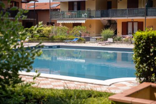 a large swimming pool in front of a building at La casa di Monica con piscina e terrazza in Moniga