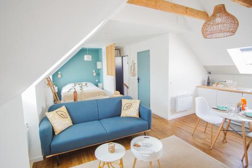 un salon avec un canapé bleu et une chambre dans l'établissement -PICCO BIANCO-Studio entierement renove-Concarneau, à Concarneau