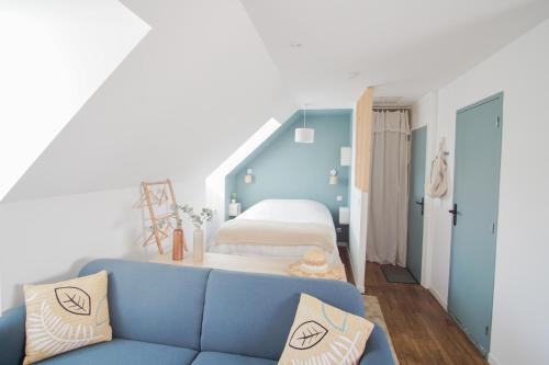 - un salon avec un canapé bleu et un lit dans l'établissement -PICCO BIANCO-Studio entierement renove-Concarneau, à Concarneau