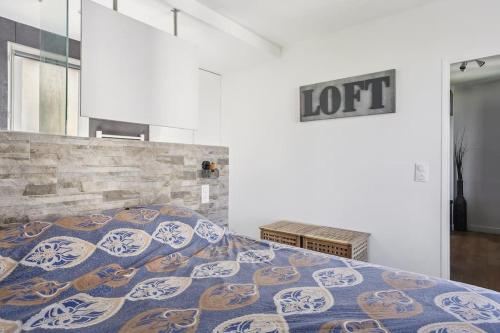 a bedroom with a bed with a colorful blanket at 9-minute walk from La Défense - 1 bedroom in Courbevoie