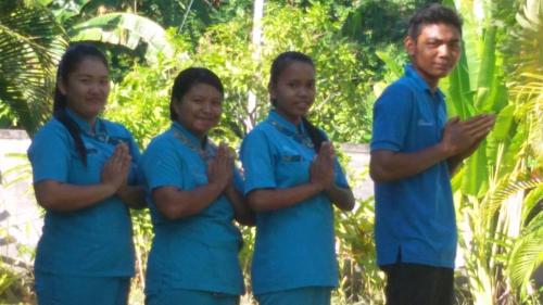 a group of people wearing blue uniforms standing together at Villa Danison in Umeanyar