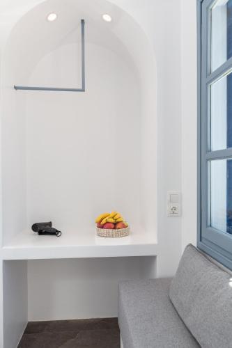 a bowl of fruit sitting on a counter next to a window at Aitheras Luxury Suites in Protorgia